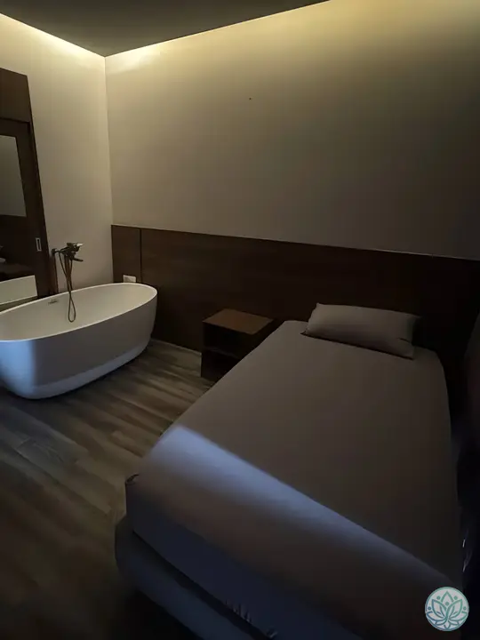 욕조와 싱글 베드가 함께 자리한 룸